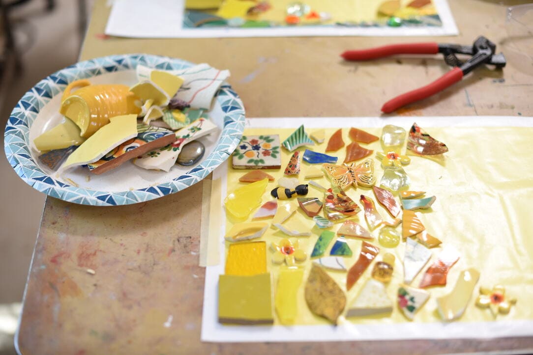 broken ceramic pieces being arranged as art