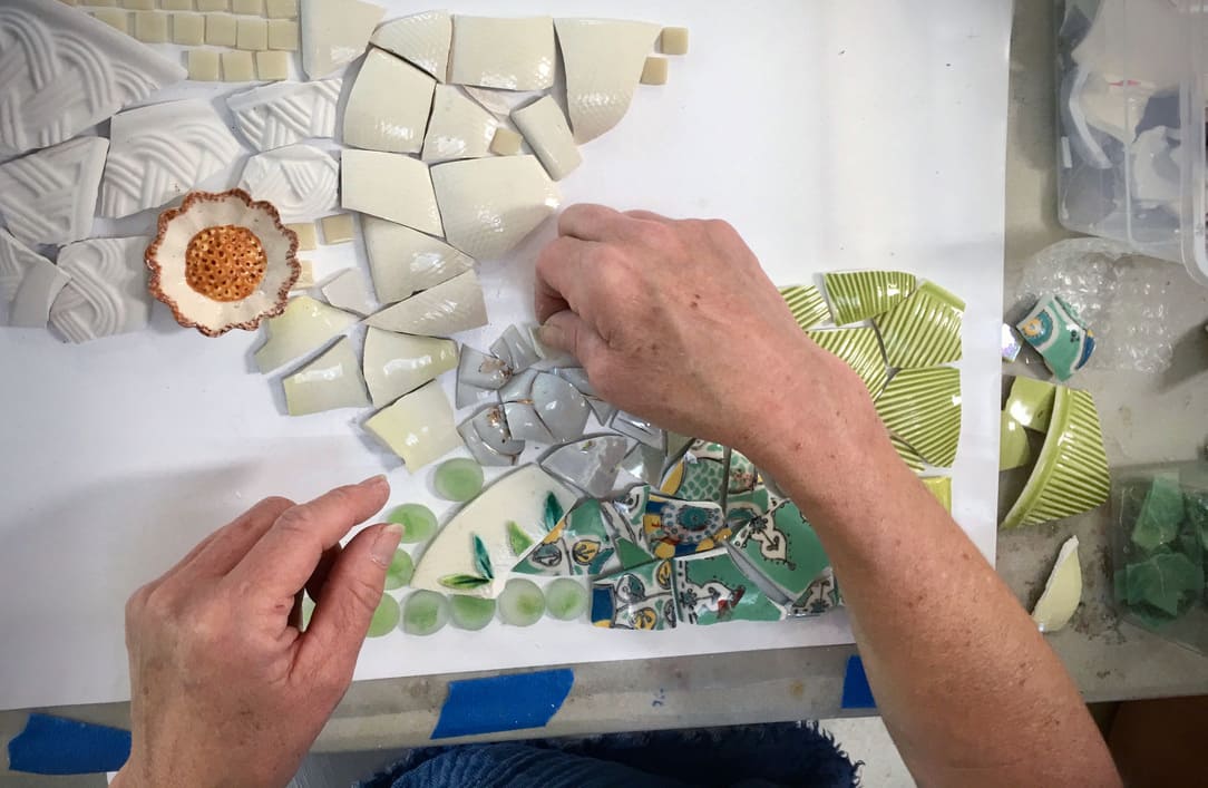 broken ceramic pieces being arranged as art